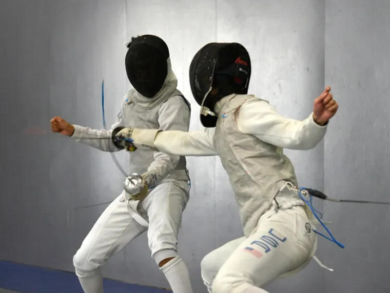 Close-up of fencing equipment — mask and blade